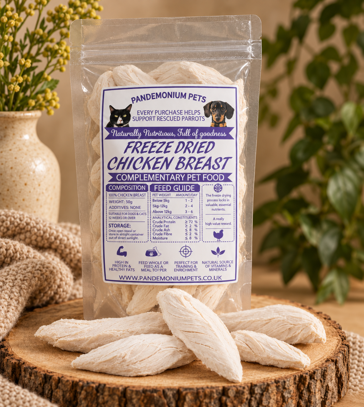 Pandemonium Pets freeze dried chicken breast pet treats in a clear 50g bag with pieces displayed on a wooden stand