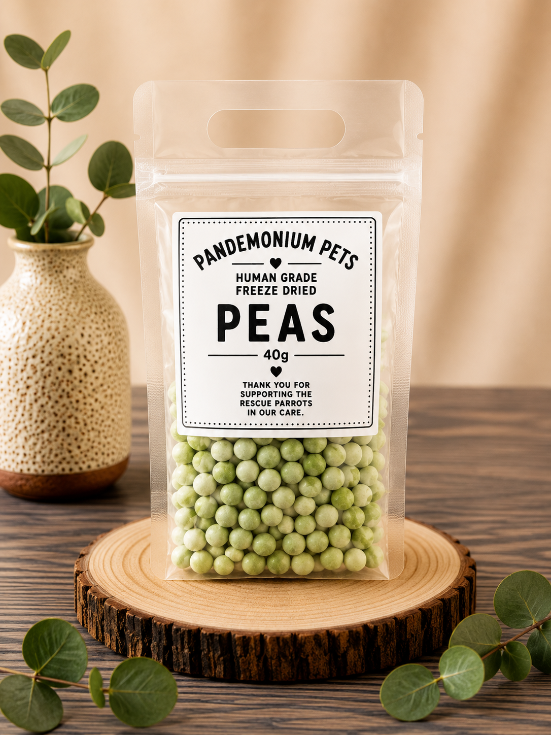 Pandemonium Pets Human Grade Freeze Dried Peas 40g in a clear resealable pouch on a wooden slice