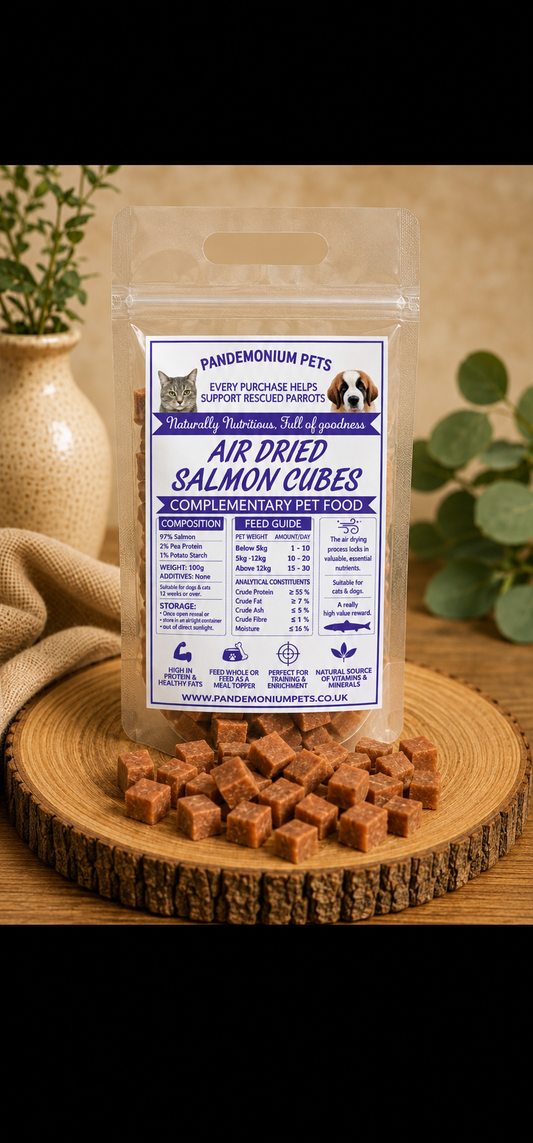 Air dried salmon cubes in a resealable Pandemonium Pets pouch with salmon cubes on a wooden board
