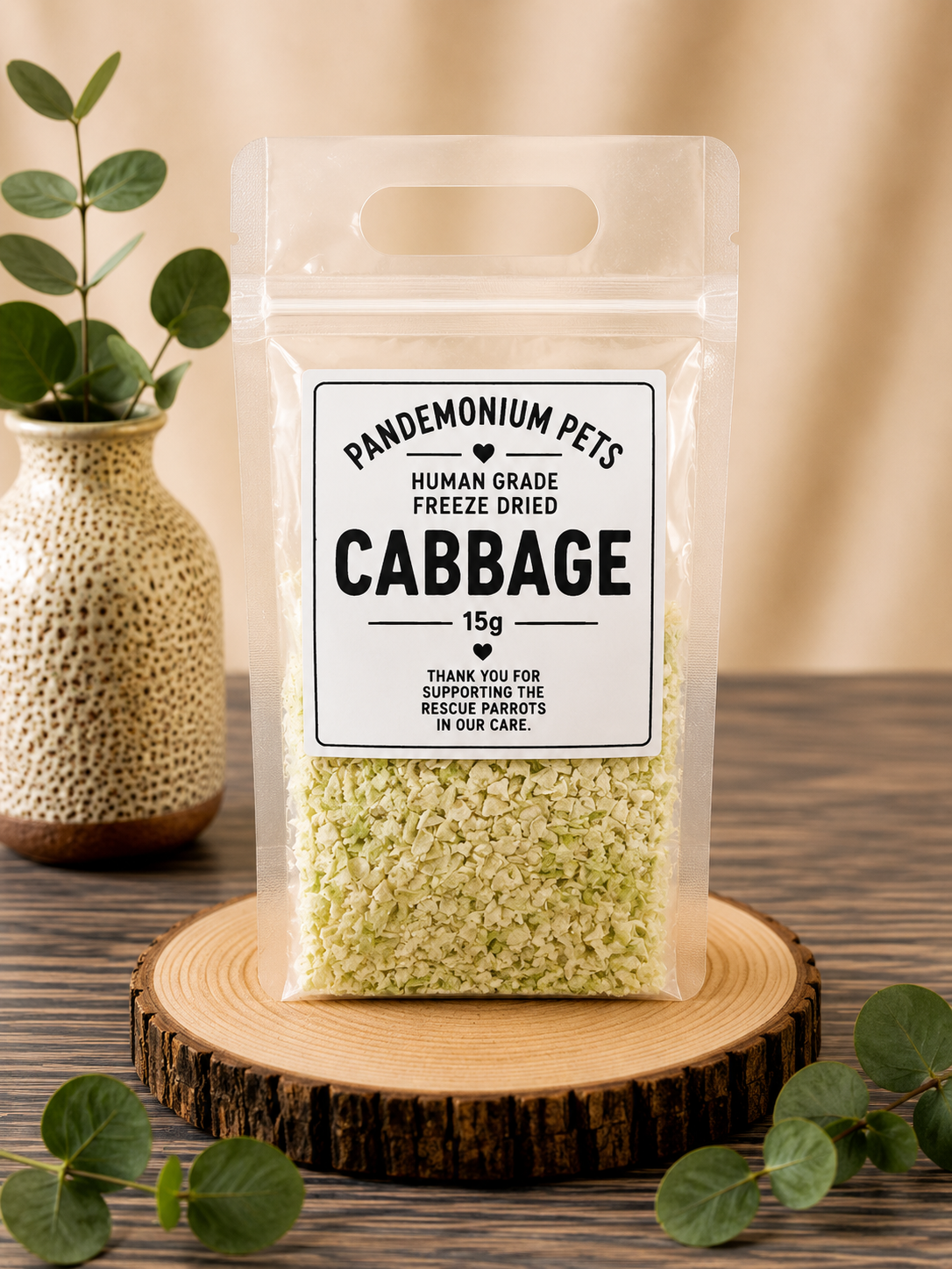 Pandemonium Pets Human Grade Freeze Dried Cabbage 15g in a clear resealable pouch on a wooden slice