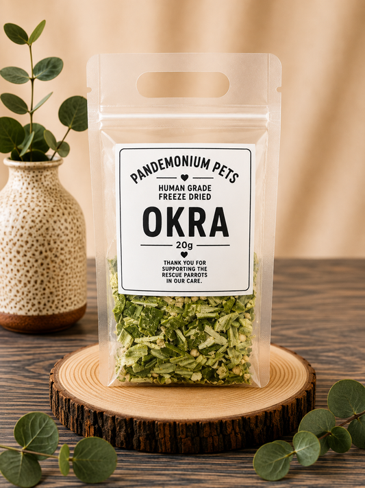 Pandemonium Pets Human Grade Freeze Dried Okra 20g in a clear resealable pouch on a wooden slice