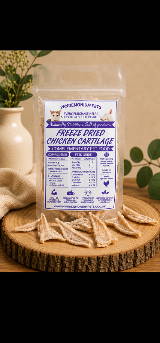 Freeze dried chicken cartilage in a resealable Pandemonium Pets pouch with chicken cartilage pieces on a wooden board