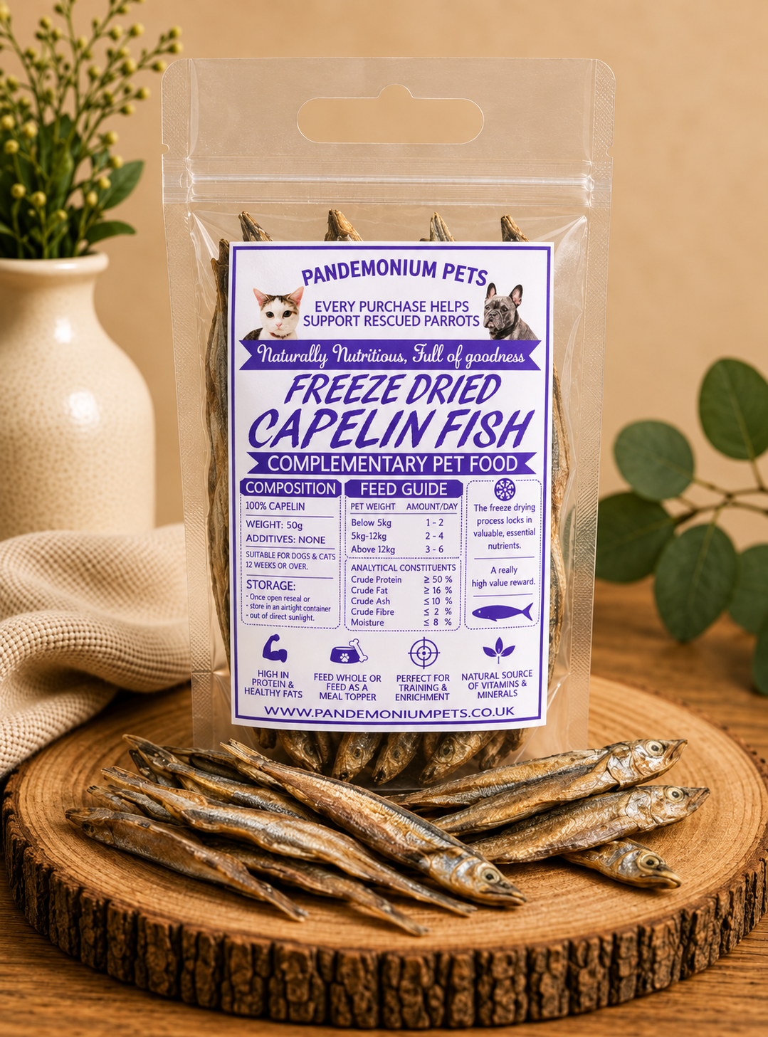 Freeze dried capelin fish in a resealable Pandemonium Pets pouch with whole capelin fish on a wooden board